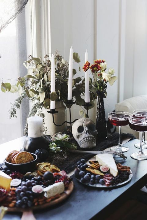 skull decor and candles with florals