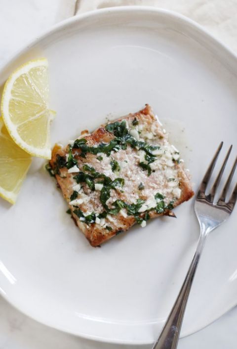 salmon on plate with lemons and fork