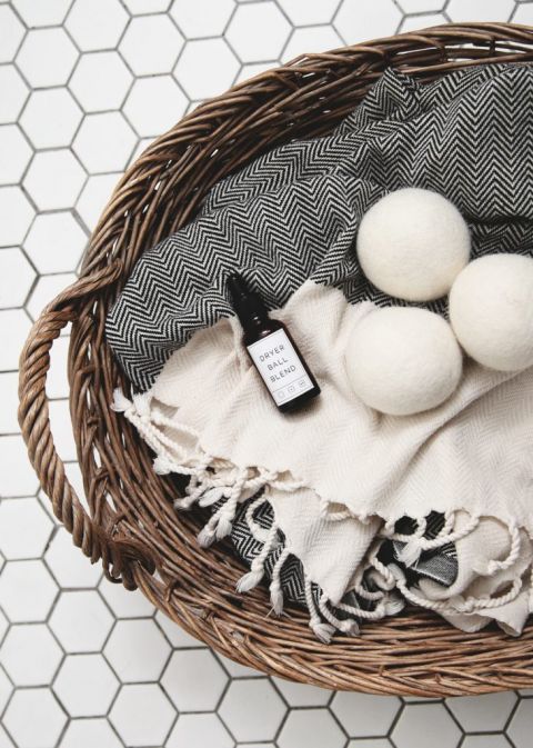 laundry basket with towel and dryer balls in it