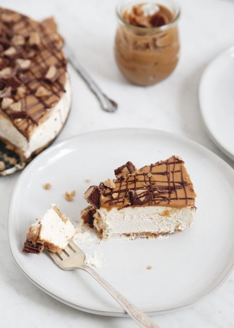 slice of no bake peanut butter cheesecake on a white plate with fork
