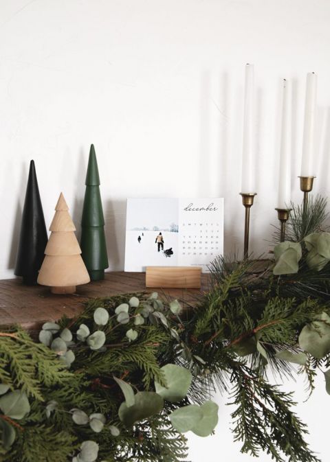 calendar on wood mantel with christmas decor