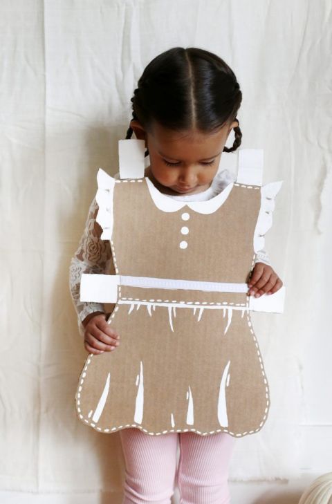 little girl in cardboard paper doll costume