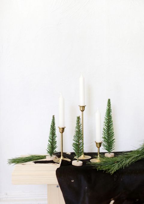 candles on gold stands with mini Christmas trees
