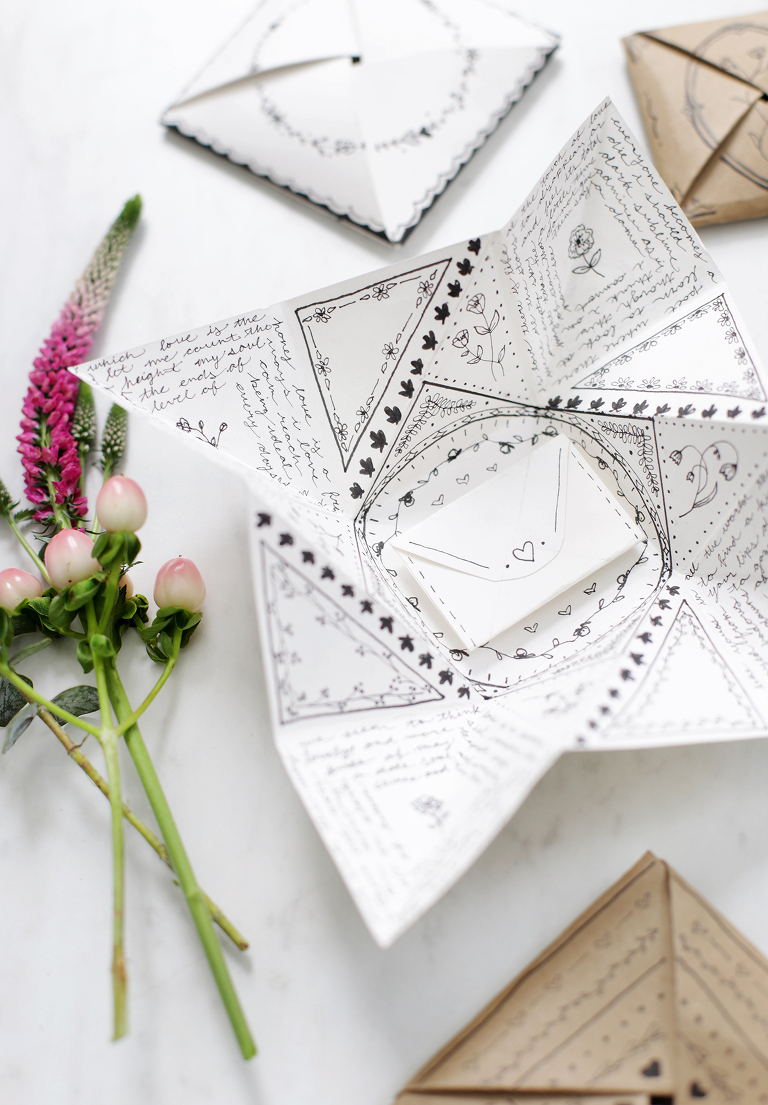 white paper victorian purse with black doodles next to pink florals