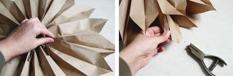close up of paper bag being pinched and hole punched