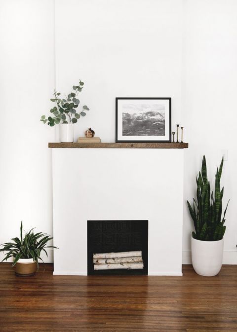 white fireplace surround with wood mantle