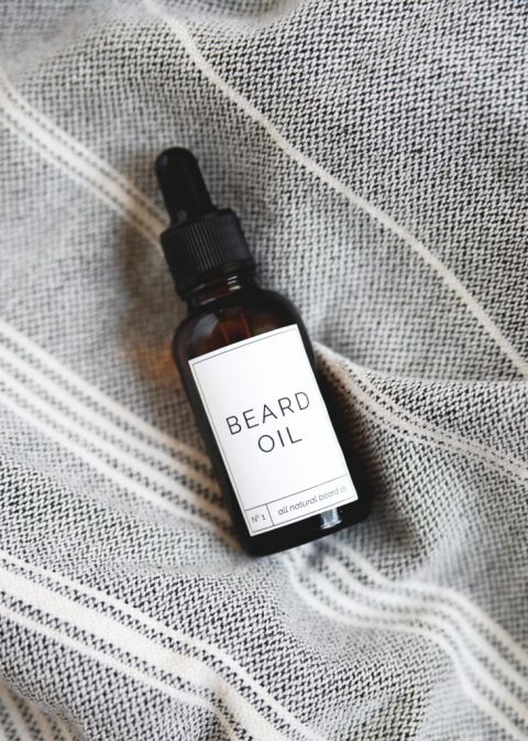 diy beard oil bottle lying on towel