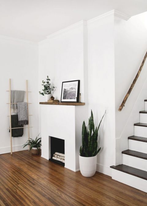 white fireplace surround with wood mantle