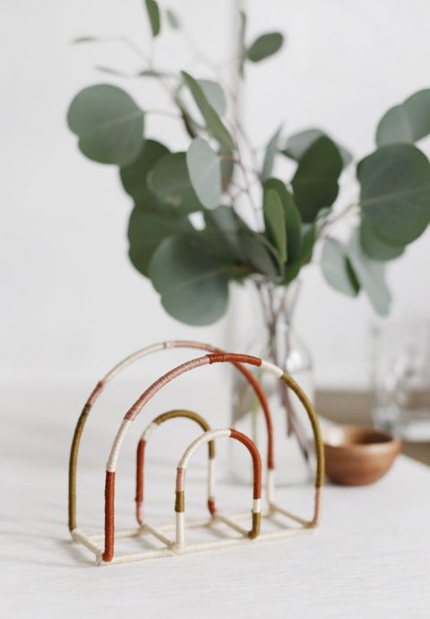 empty rainbow napkin holder in front of eucalyptus