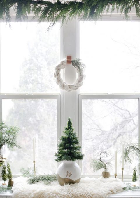 small Christmas tree and wreath in window