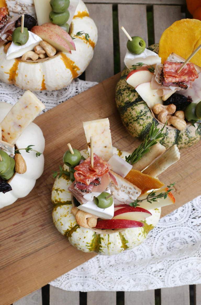 overhead shot of mini charcuterie displays inside mini pumkins