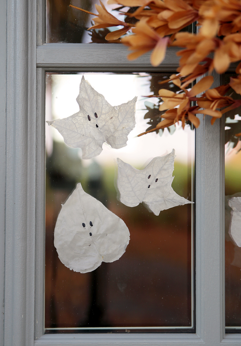 window cling glue ghost leaves on window with fall wreath in corner of photo