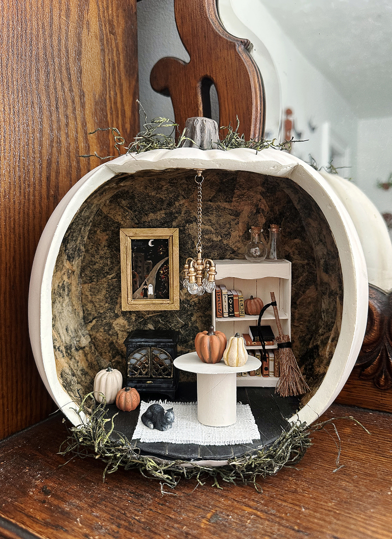 dollhouse inside of carved craft pumpkin with halloween decor