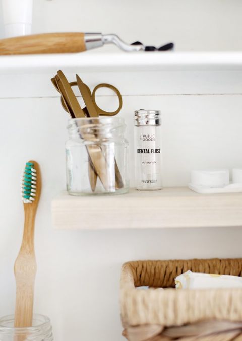 small wooden shelf inside white medicine cabinet with toiletries
