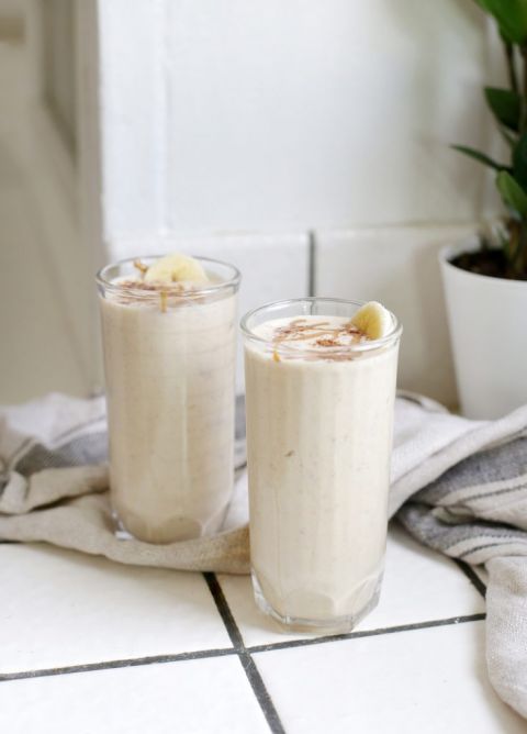 two cups full of smoothie on white tiled counter