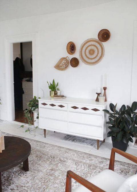 mid-century modern white dresser under basket wall