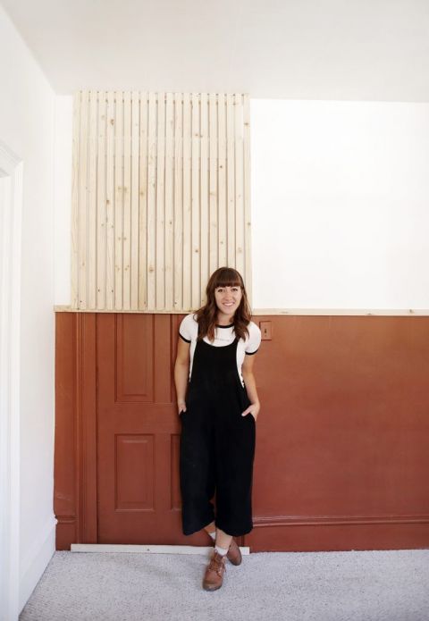 woman in front of painted and slat accent wall