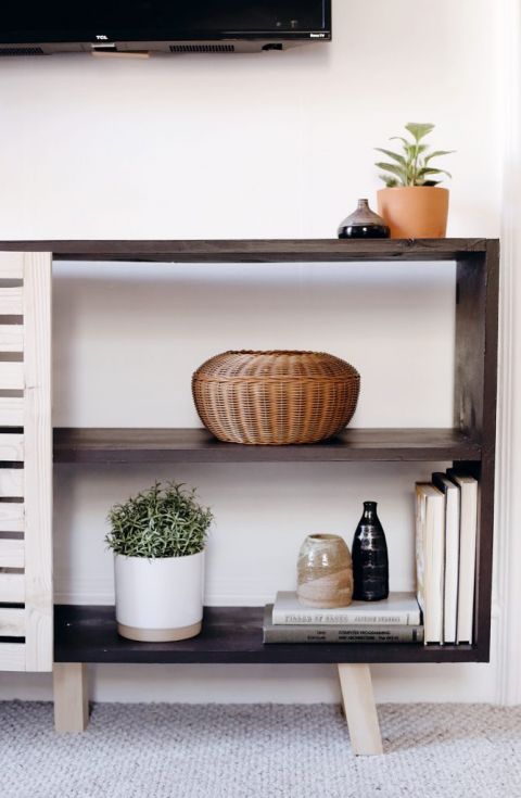 close up of black shelves with books and vases