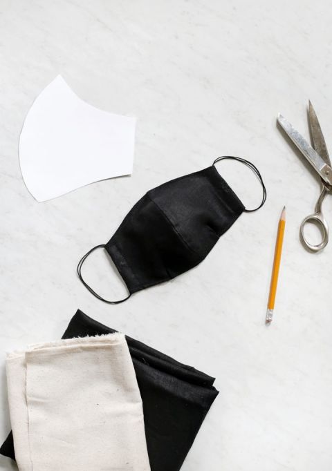mask on ground with scissors, fabric, and pattern