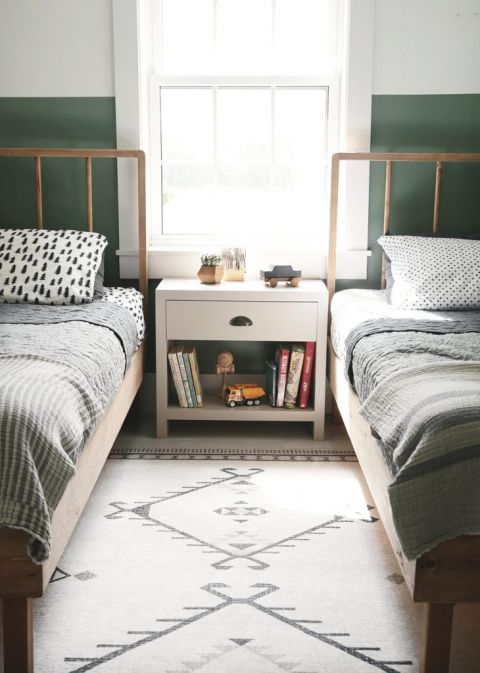 twin beds in front of window with nightstand between