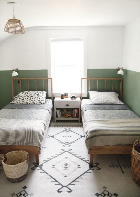 two twin wood beds in green and white kids room