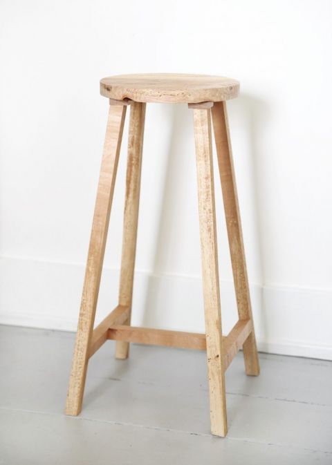 simple wood stool against white wall