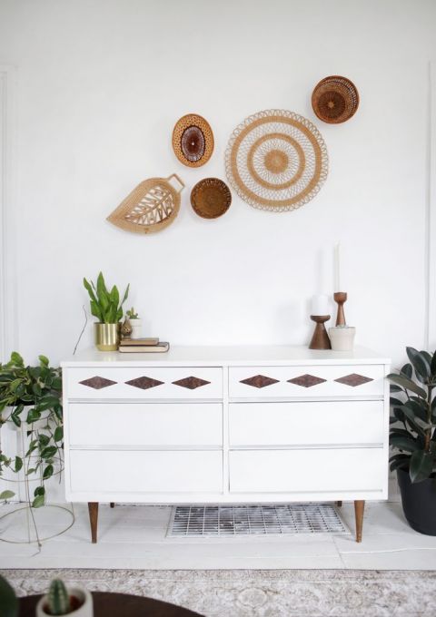 mid-century modern white dresser under basket wall