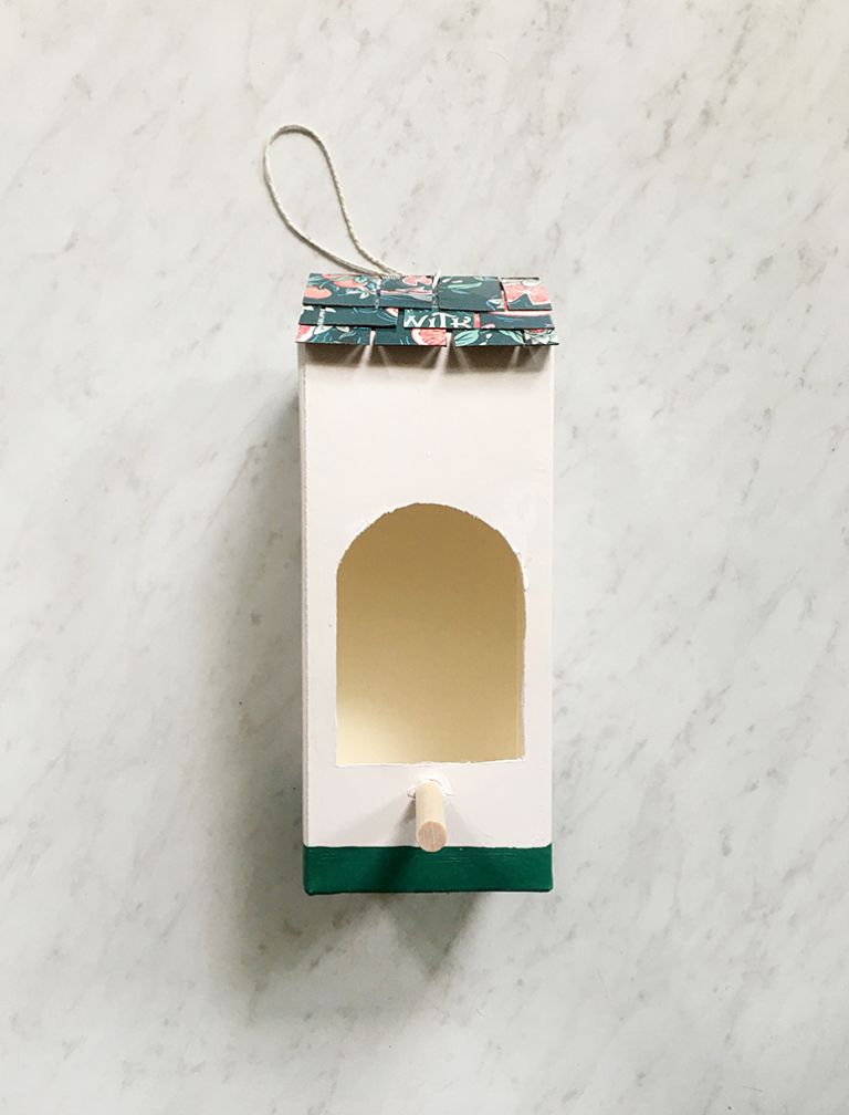 teal and white birdhouse made from milk carton