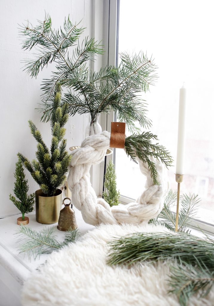 close up of cotton wreath and Christmas greens
