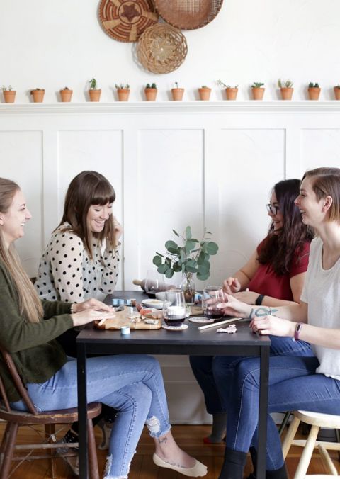 group of girls around table at crafternoon clay jewelry making party
