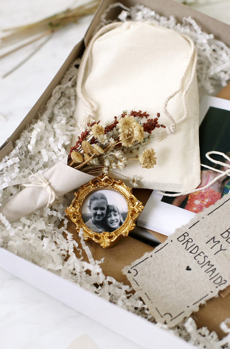 small framed photo next to mini dried bouquet, photos and letter