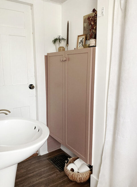 brown pink cabinet doors in white bathroom