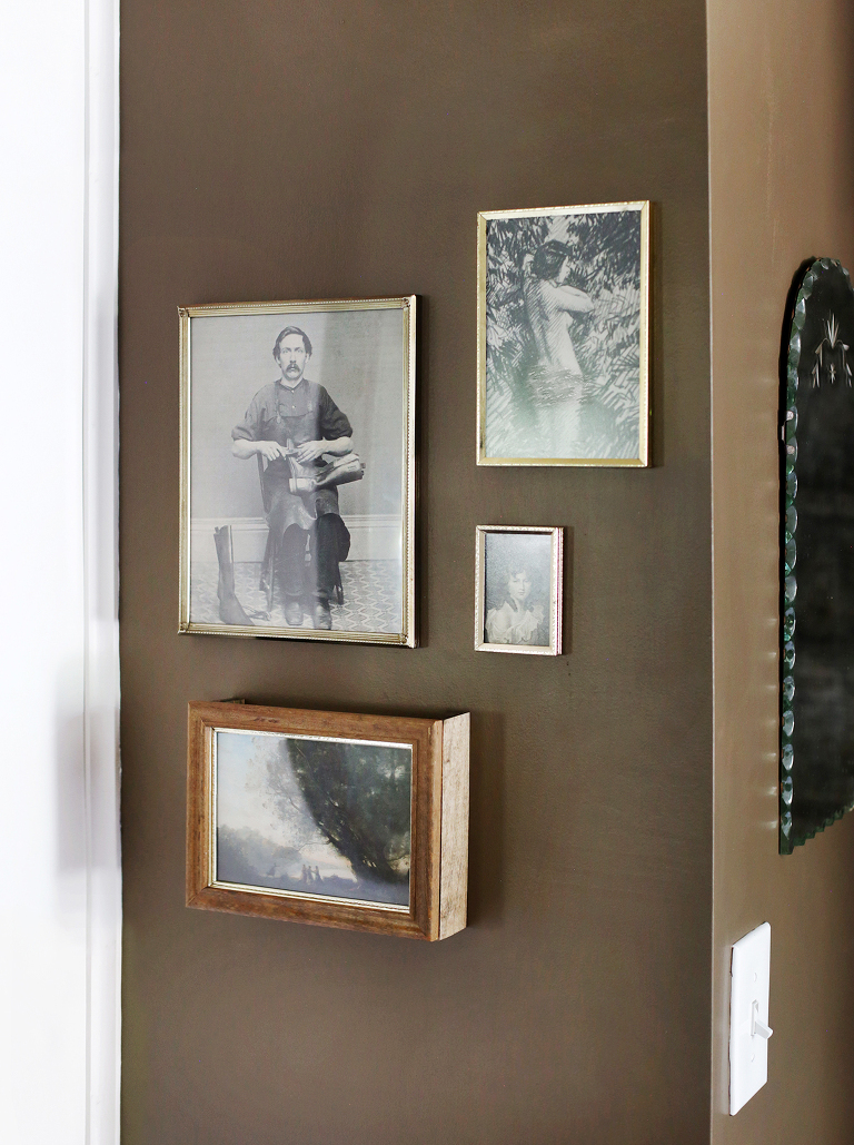 wood and gold vintage frame gallery wall on brown wall