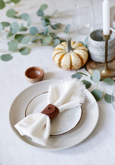 leather napkin ring on plate setting with minimal fall table runner