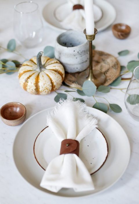 leather napkin ring on plate setting with minimal fall table runner