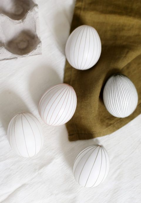 five diy string eggs on various linens