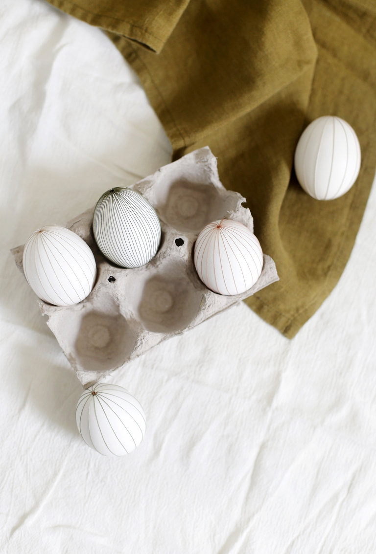 cardboard egg carton with eggs in and around it