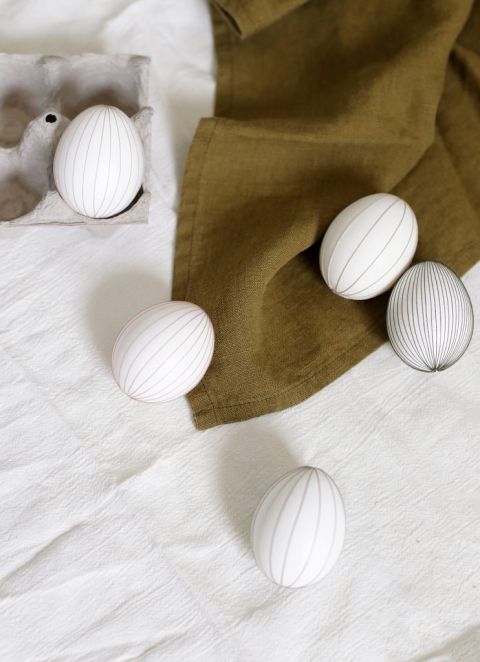 string eggs laying on various linens