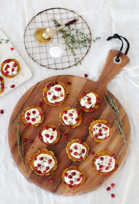 platters of appetizers surrounded by herbs and pomegranate seeds