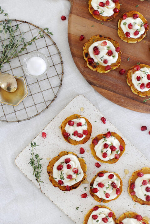 platters of delicata squash with whipped goat cheese surrounded by extra ingredients