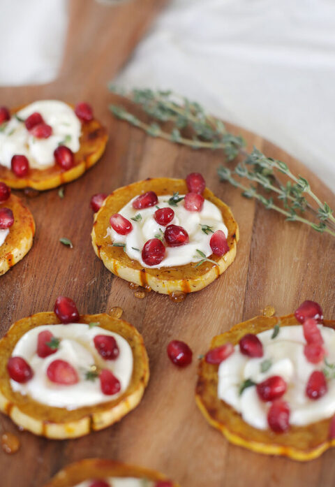 close up of delicata squash rings on wooden cutting board