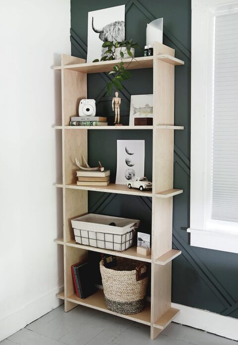 plywood shelf against blue wall