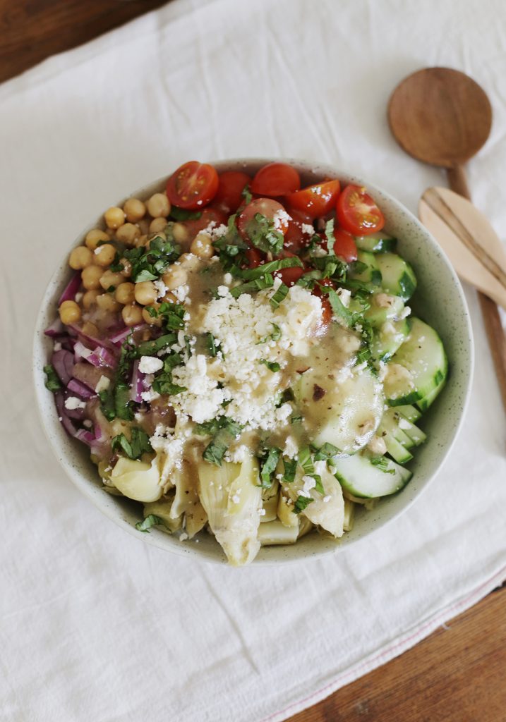 large serving bowl overhead shot of artichoke salad before mixed