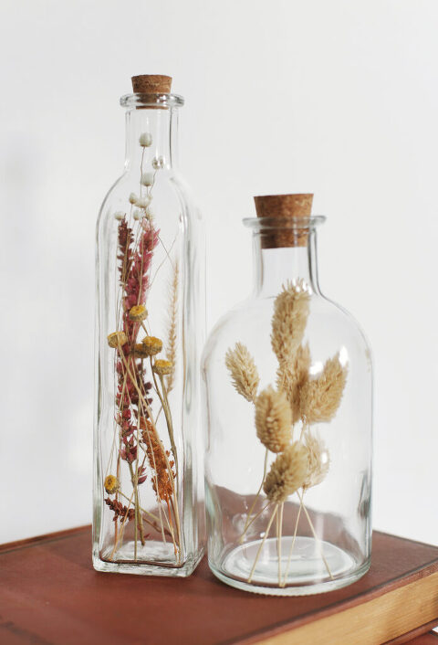 flowers in two well-spoken bottles with corks