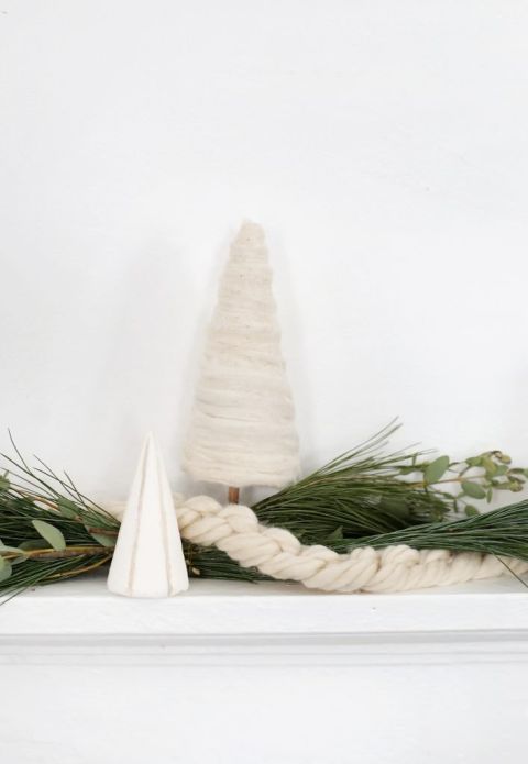 yarn and greenery garlands around mini tree decor