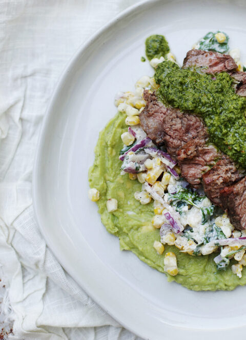 close up of steak dinner on white plate