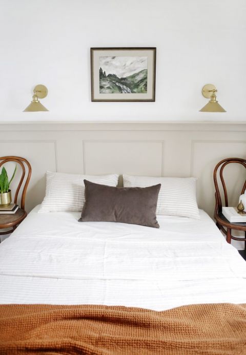 bedroom with taupe half wall and neutral decor pieces