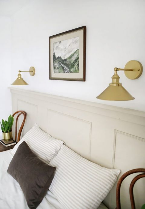 gold wall sconces on painted feature wall