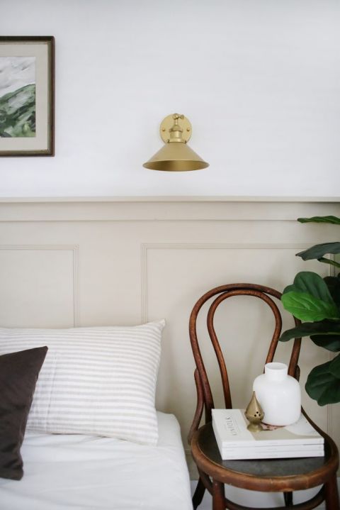 close up of wall sconce and chair nightstand