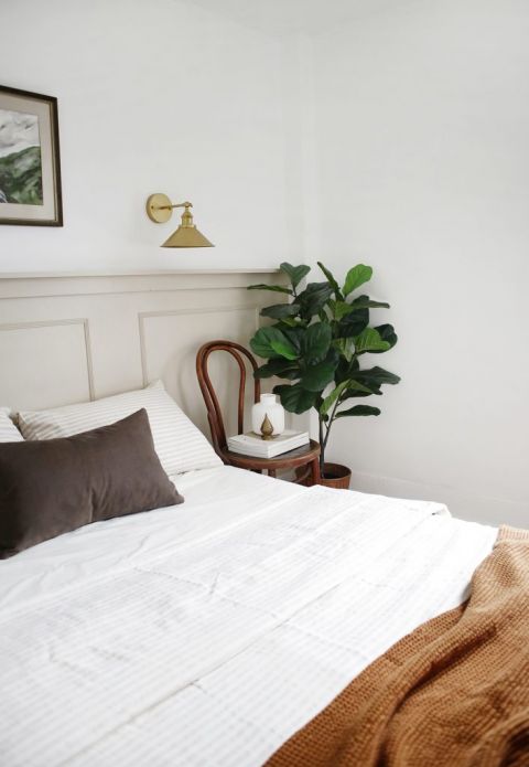 bedroom with taupe half wall and neutral decor pieces